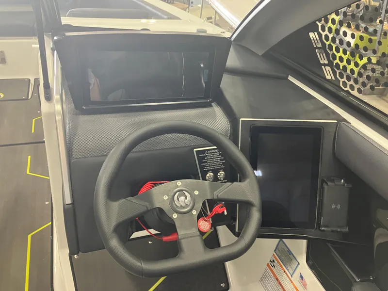 Slide: The Image of 2024 Scarab 285 boat dashboard with steering wheel and digital displays. - 19