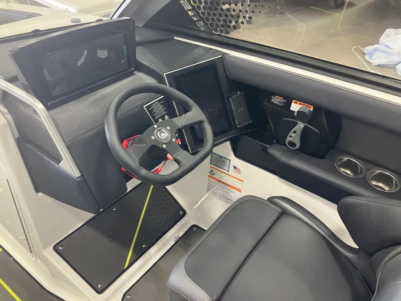 Slide: The Image of 2024 Scarab 285 boat cockpit with steering wheel and control panel. - 6
