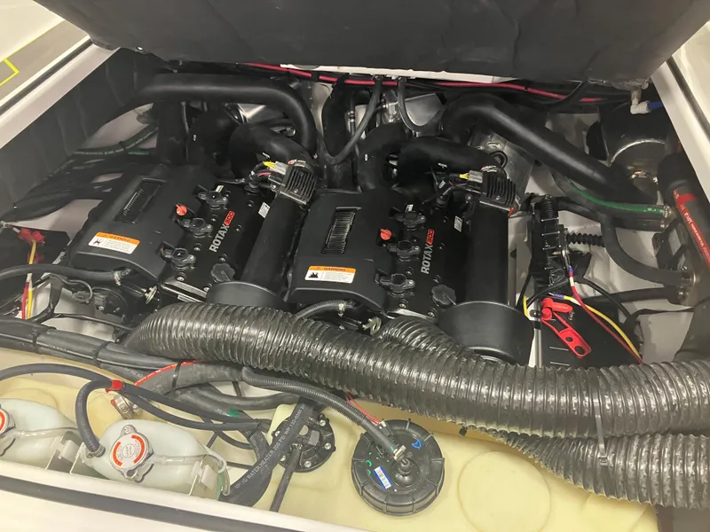 Slide: The Image of 2024 Scarab 285 boat engine compartment with dual Rotax engines. - 7