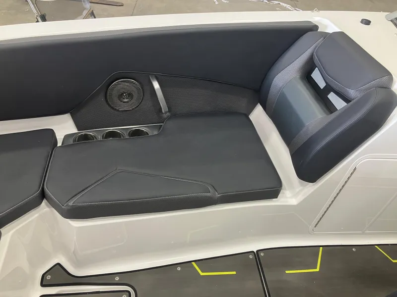 Slide: The Image of 2024 Scarab 285 boat interior seating with black cushions and built-in cup holders. - 9