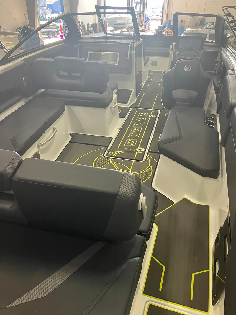 Slide: The Image of 2024 Scarab 285 boat in a showroom, black and yellow design, on a trailer. - 3