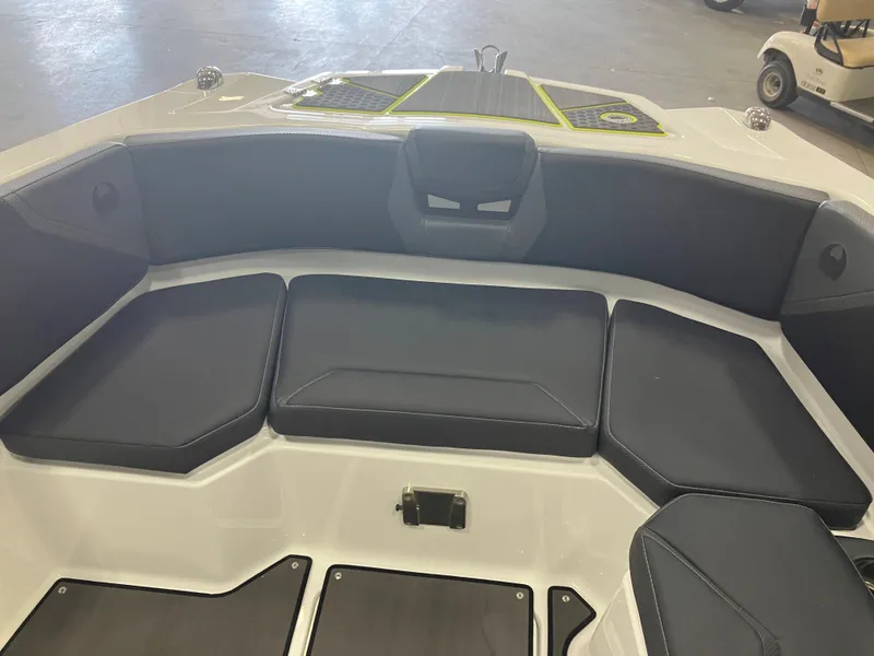 Slide: The Image of 2024 Scarab 285 boat in yellow and black, displayed indoors on a trailer. - 4