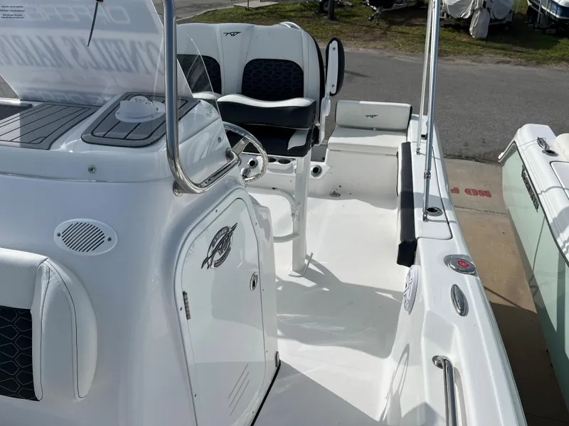 Slide: The Image of 2024 Tidewater 198 CC boat interior with seating and console. - 13
