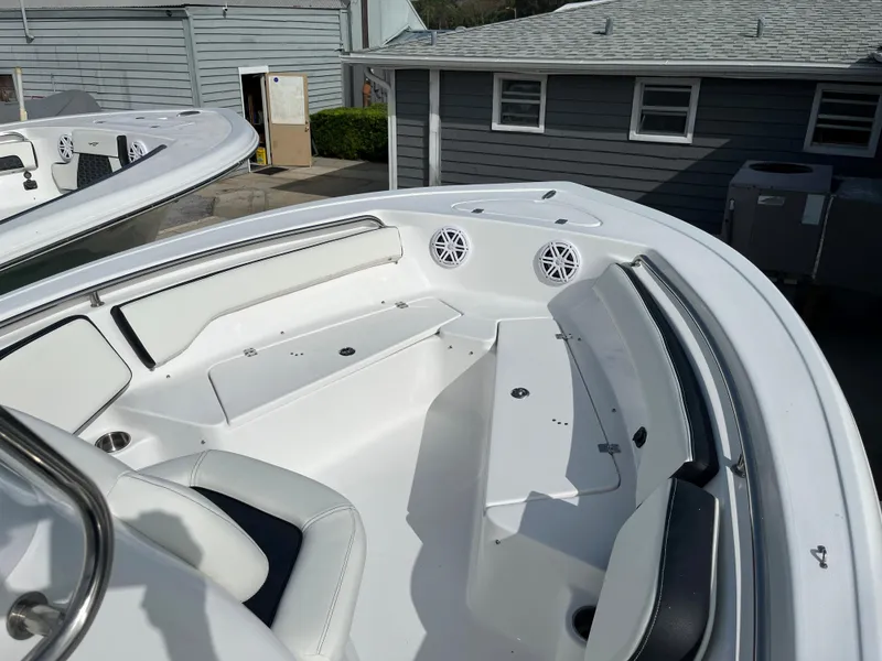 Slide: The Image of 2024 Tidewater 198 CC boat interior with white seating and storage compartments. - 5