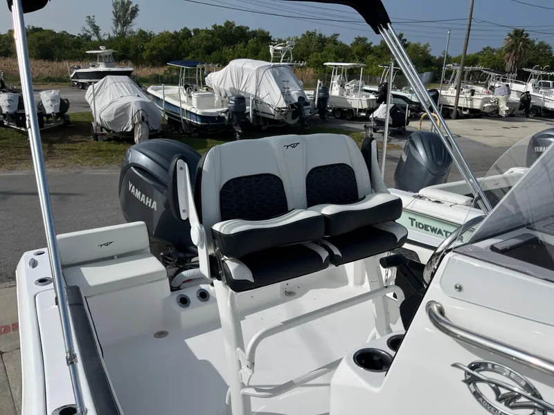 Slide: The Image of 2024 Tidewater 198 CC boat with Yamaha engine, docked in a marina. - 8