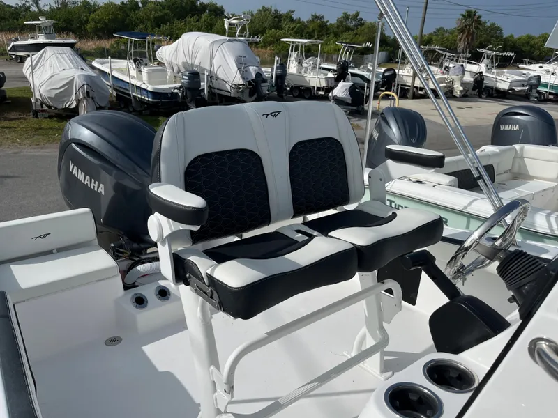 Slide: The Image of 2024 Tidewater 198 CC boat with Yamaha engine, dual seats, and cup holders. - 9