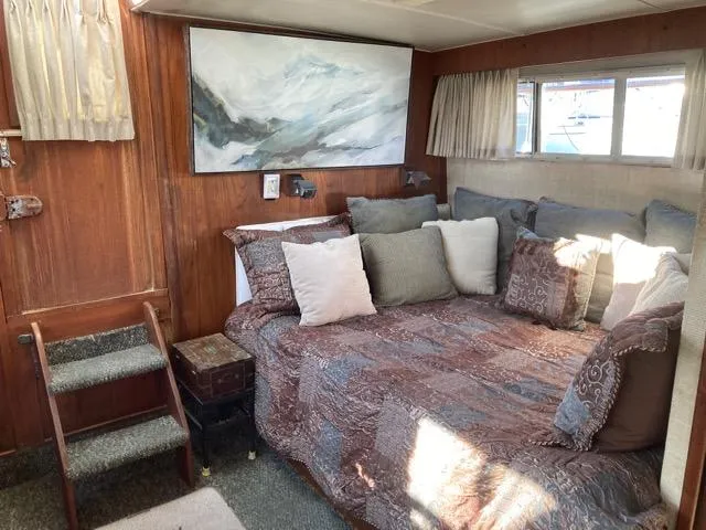 Slide: The Image of Cozy interior of 1977 Tollycraft 48' Cockpit Motor Yacht with bed and decorative pillows. - 5
