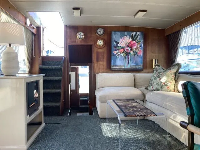 Slide: The Image of 1977 Tollycraft 48' Cockpit Motor Yacht interior with cozy seating and elegant decor. - 6