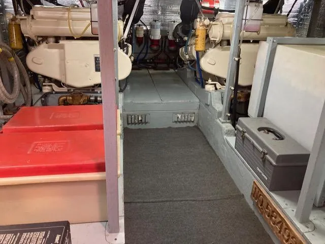 Slide: The Image of Engine room of a 1977 Tollycraft 48' Cockpit Motor Yacht with visible machinery and storage. - 8
