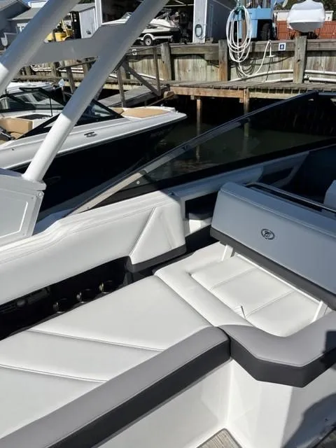 Slide: The Image of 2021 Cobalt R6 boat with white and gray interior at a marina. - 11