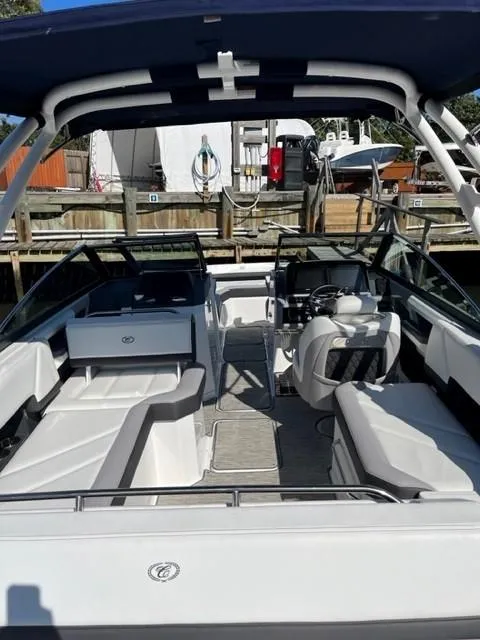 Slide: The Image of 2021 Cobalt R6 boat with spacious seating and modern design docked at a marina. - 18