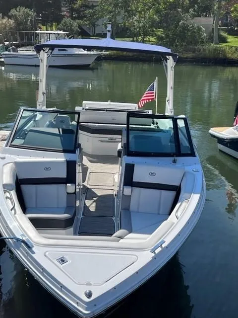 Slide: The Image of 2021 Cobalt R6 boat docked in a serene marina with American flag. - 20