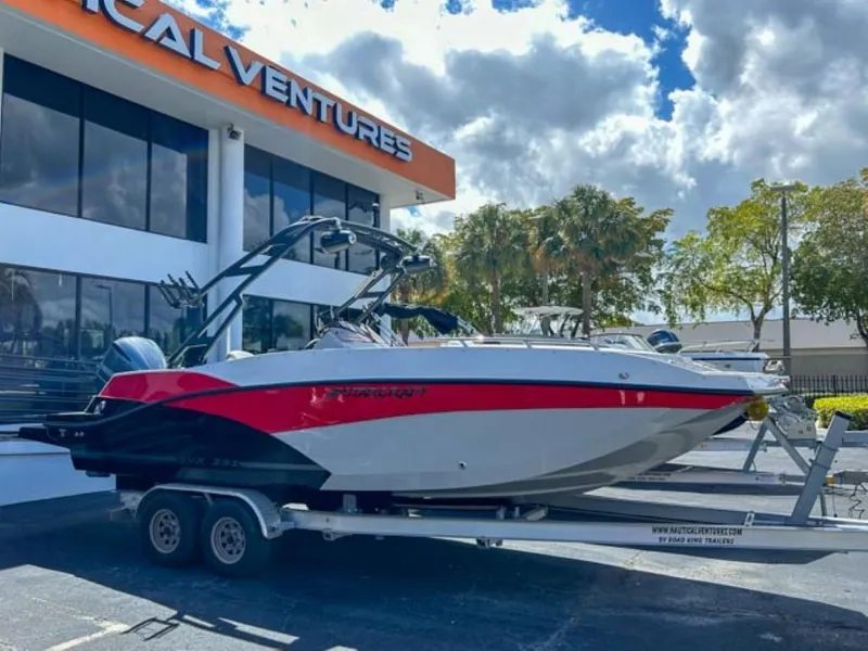Slide: The Image of 2024 Starcraft SVX 231 OB DH boat on a trailer outside a dealership. - 0