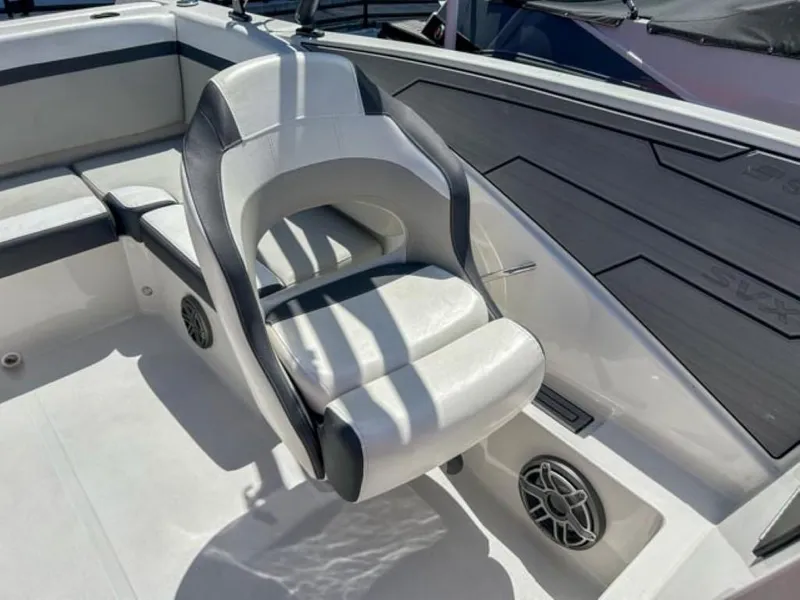 Slide: The Image of 2024 Starcraft SVX 231 OB DH boat interior with white and gray seating. - 7