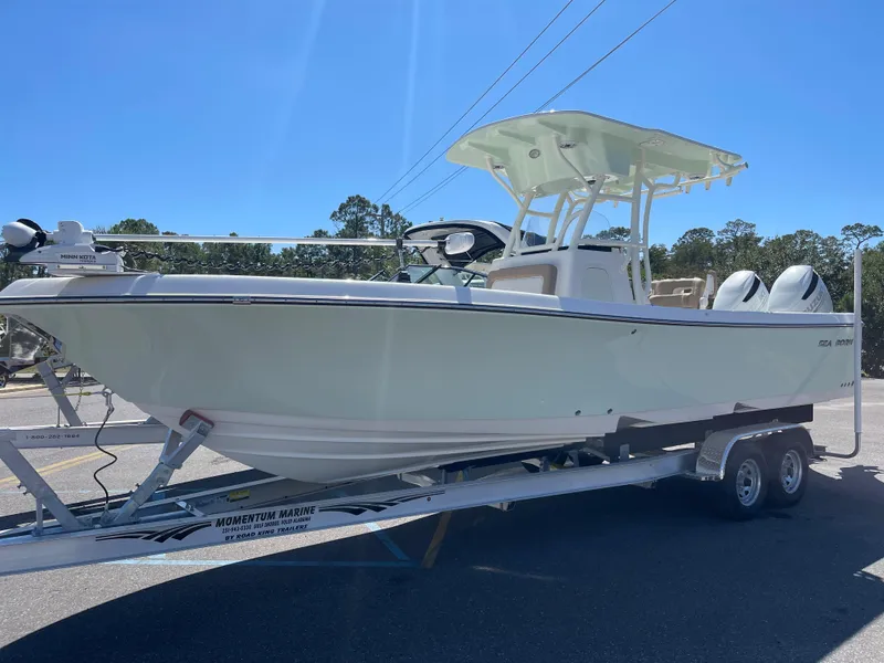 The Image of 2024 Sea Born LX 26 boat on trailer under clear blue sky. - 1