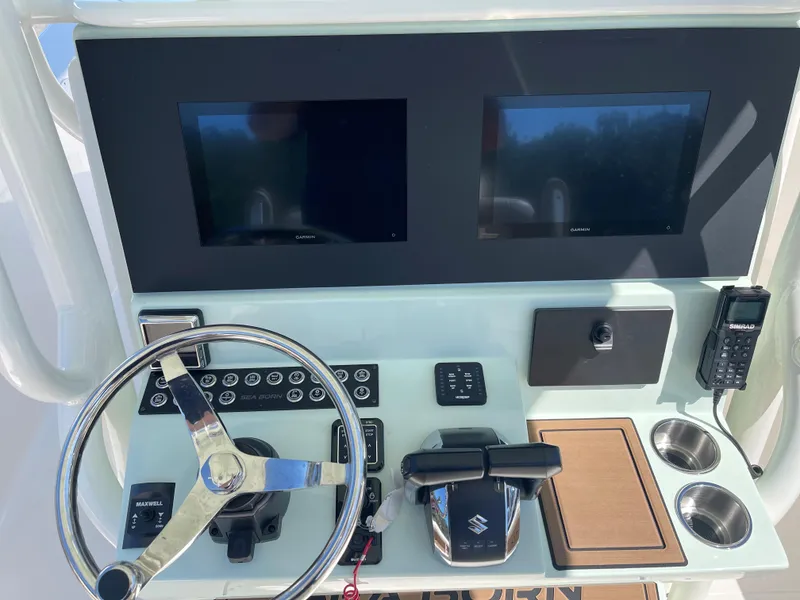 Slide: The Image of 2024 Sea Born LX 26 boat dashboard with dual screens and steering wheel. - 5