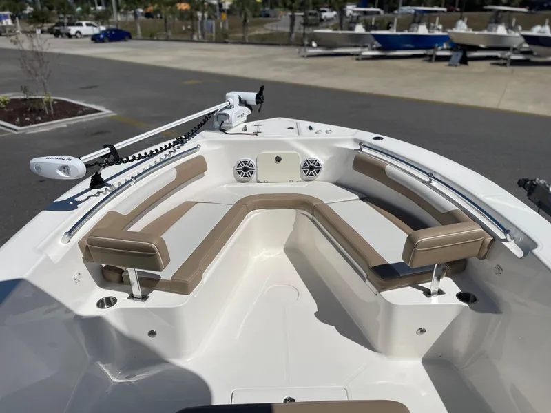 Slide: The Image of 2024 Sea Born LX 26 boat bow seating area with tan cushions and mounted trolling motor. - 8
