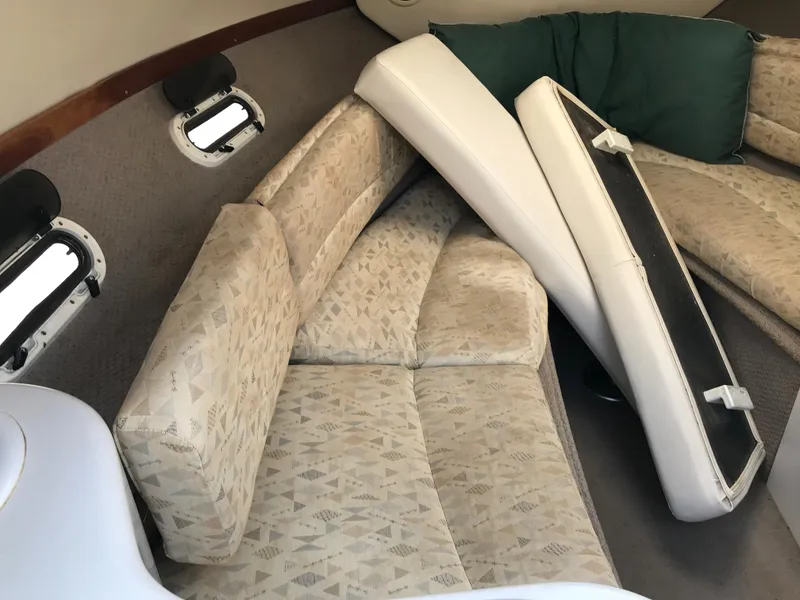 Slide: The Image of Interior cabin of a 2002 Four Winns 245 Sundowner boat with cushioned seating. - 12