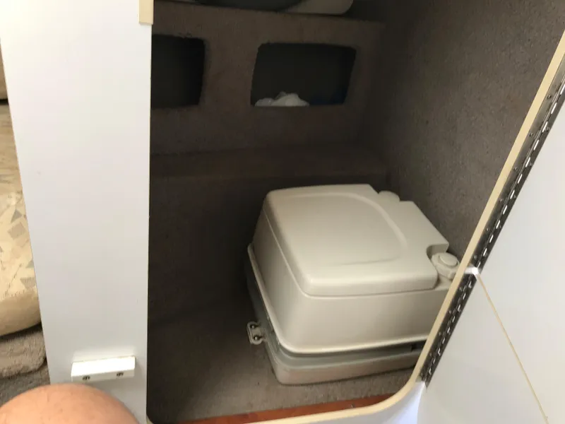 Slide: The Image of 2002 Four Winns 245 Sundowner cabin with portable toilet. - 13