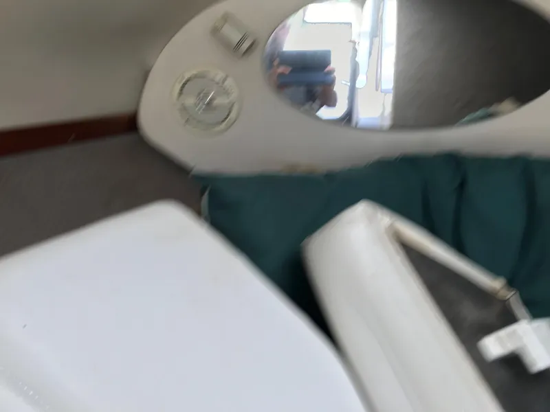 Slide: The Image of Interior cabin of a 2002 Four Winns 245 Sundowner boat with mirror and seating. - 18