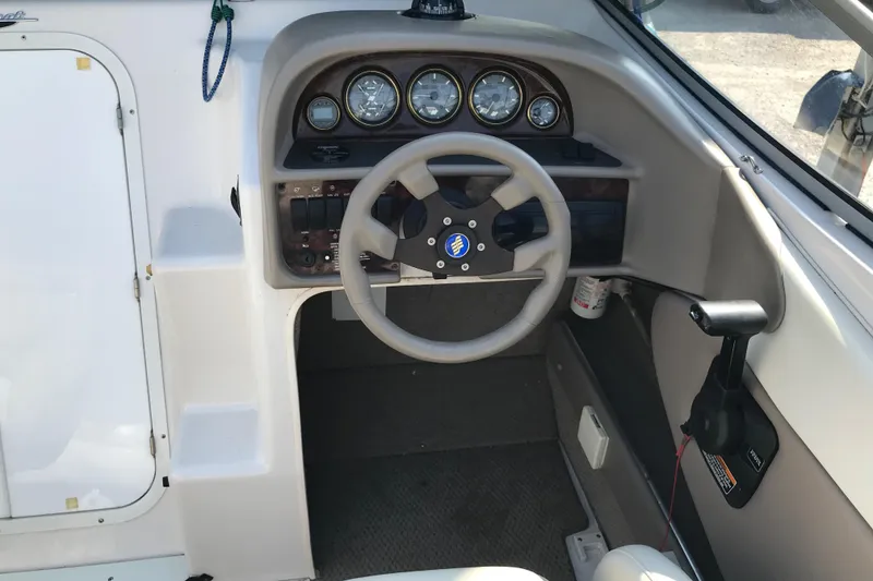 Slide: The Image of 2002 Four Winns 245 Sundowner boat helm with steering wheel and instrument panel. - 20