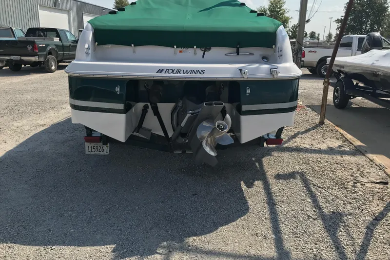 Slide: The Image of 2002 Four Winns 245 Sundowner boat with green cover, rear view. - 21