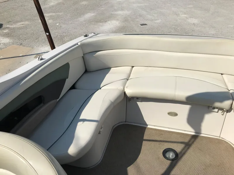 Slide: The Image of 2002 Four Winns 245 Sundowner boat interior with beige leather seating. - 6
