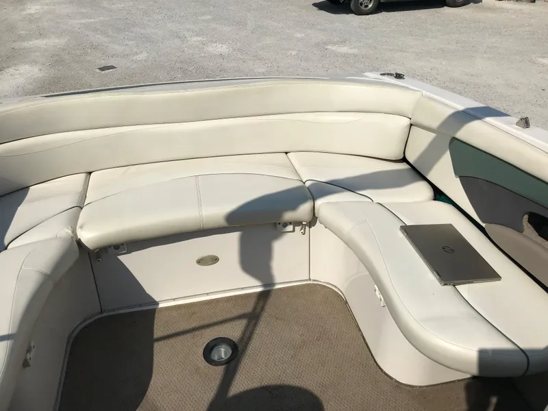 Slide: The Image of 2002 Four Winns 245 Sundowner boat interior with beige seating and carpet. - 7