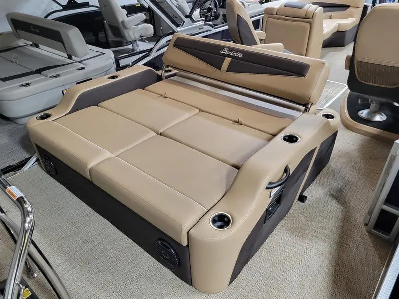 Slide: The Image of 2024 Barletta C22UC pontoon boat with luxurious tan seating and cup holders. - 10