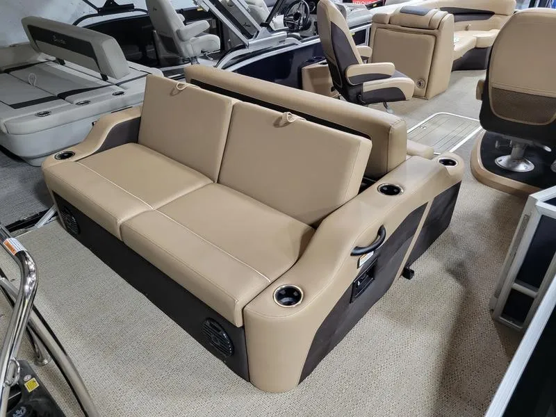 Slide: The Image of 2024 Barletta C22UC pontoon boat interior with beige seating and cup holders. - 11