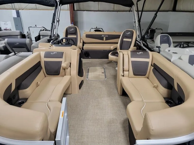 Slide: The Image of 2024 Barletta C22UC pontoon boat with luxurious tan seating and spacious interior. - 12