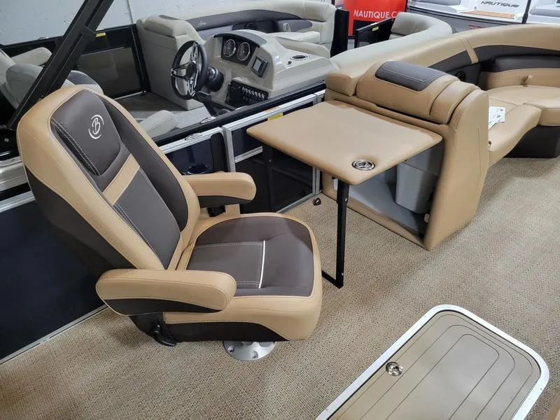Slide: The Image of 2024 Barletta C22UC boat interior with captain's chair and table, showcasing luxury design. - 5