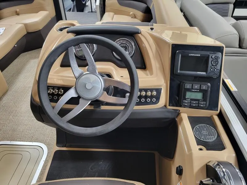 Slide: The Image of 2024 Barletta C22UC boat dashboard with steering wheel and navigation system. - 6