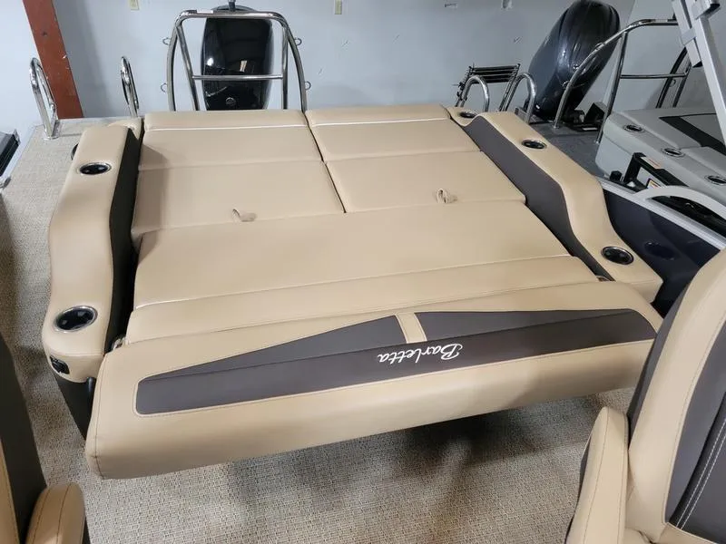 Slide: The Image of 2024 Barletta C22UC boat interior with beige seating and cup holders. - 8