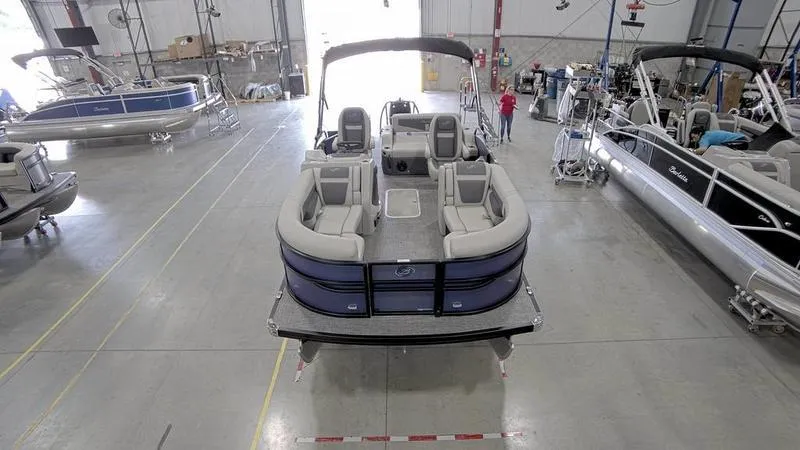 Slide: The Image of 2024 Barletta C20UC pontoon boat in a showroom. - 2