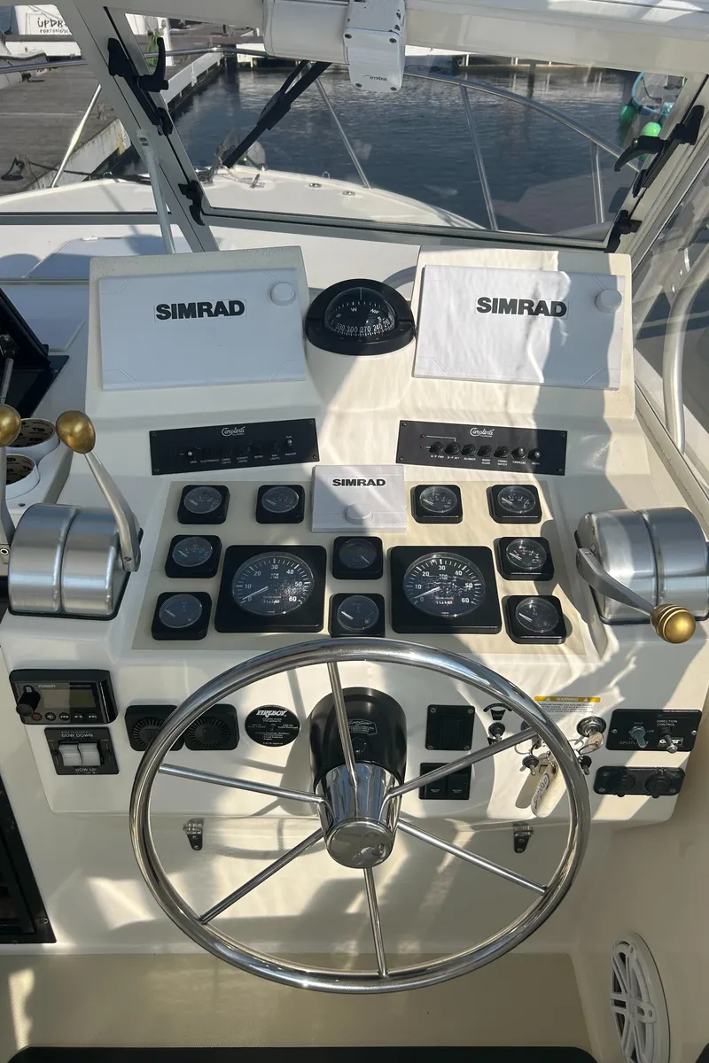 Slide: The Image of Helm of 2003 Carolina Classic 28 boat with Simrad navigation equipment. - 14