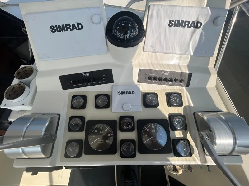 Slide: The Image of Control panel of a 2003 Carolina Classic 28 boat with Simrad navigation equipment. - 16