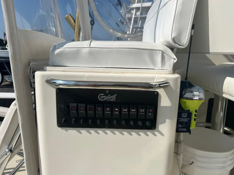 Slide: The Image of Control panel on a 2003 Carolina Classic 28 boat with white seating. - 17