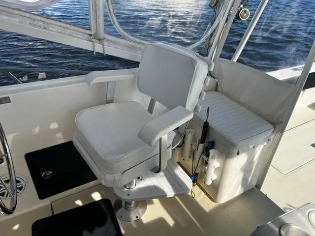 Slide: The Image of Captain's chair on 2003 Carolina Classic 28 boat, overlooking water. - 19