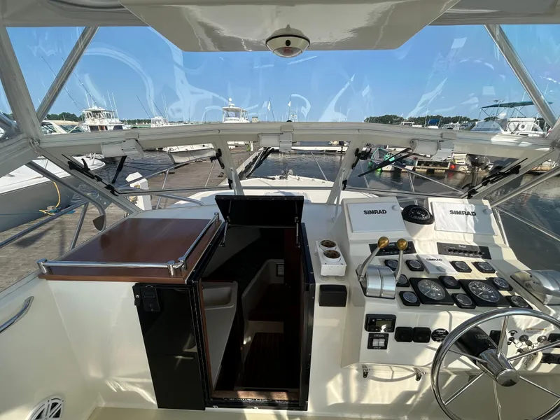 Slide: The Image of Helm of 2003 Carolina Classic 28 boat with navigation instruments and steering wheel. - 21