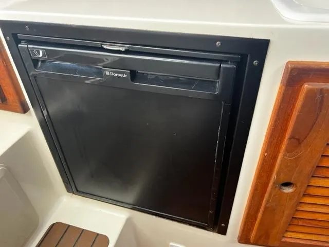 Slide: The Image of Dometic refrigerator in a 2003 Carolina Classic 28 boat interior. - 25