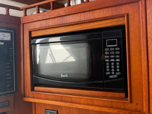 Slide: The Image of Microwave oven in wooden cabinet on 2003 Carolina Classic 28 boat. - 26