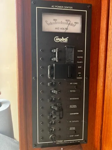 Slide: The Image of 2003 Carolina Classic 28 AC power center panel with voltage meter and switches. - 28