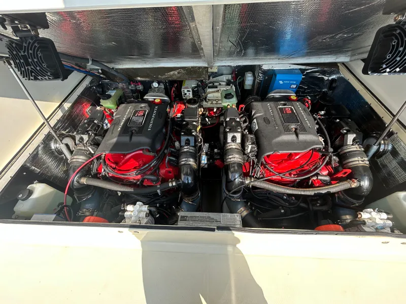 Slide: The Image of Engine compartment of a 2003 Carolina Classic 28 boat, featuring dual engines. - 32