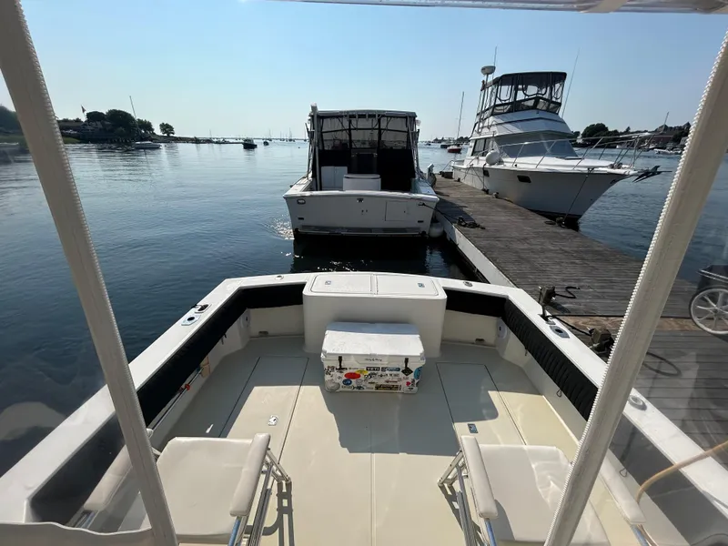 Slide: The Image of 2003 Carolina Classic 28 boat docked, spacious deck, calm water, sunny day. - 7