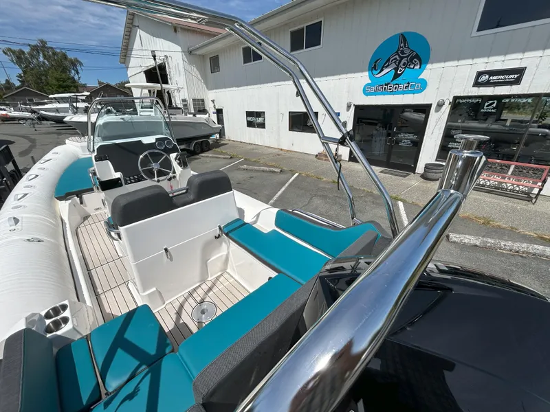Slide: The Image of 2024 Zodiac Medline 6.8 boat with teal seating at Salish Boat Co. dealership. - 10