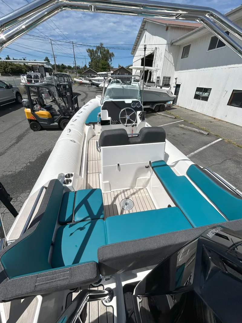 Slide: The Image of 2024 Zodiac Medline 6.8 boat with teal seating, docked outdoors. - 15