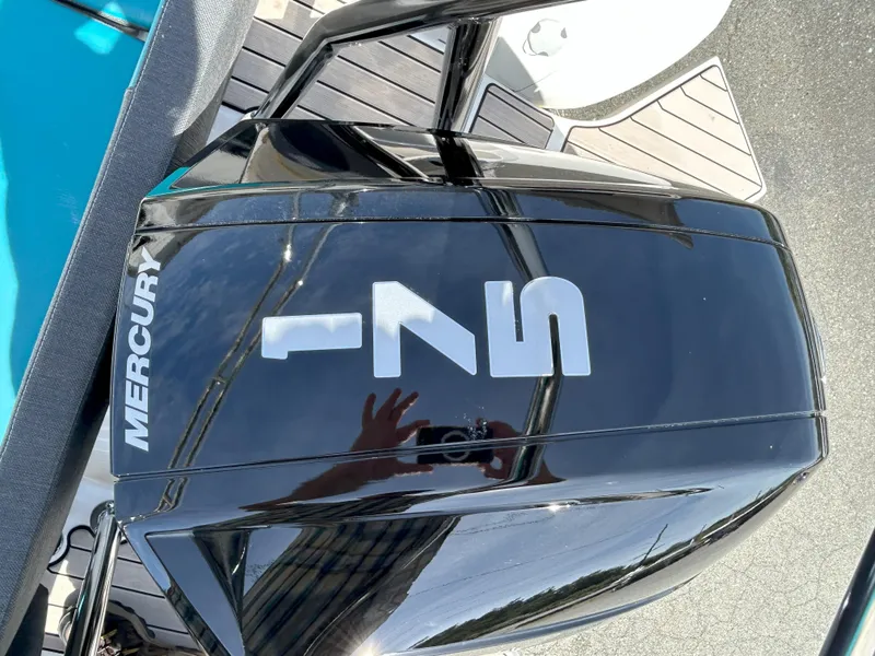 Slide: The Image of Mercury engine on 2024 Zodiac Medline 6.8 boat, reflecting surroundings. - 18