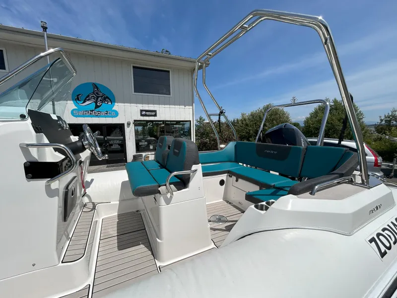 Slide: The Image of 2024 Zodiac Medline 6.8 boat with teal seating, displayed at Salish Boat Co. dealership. - 2