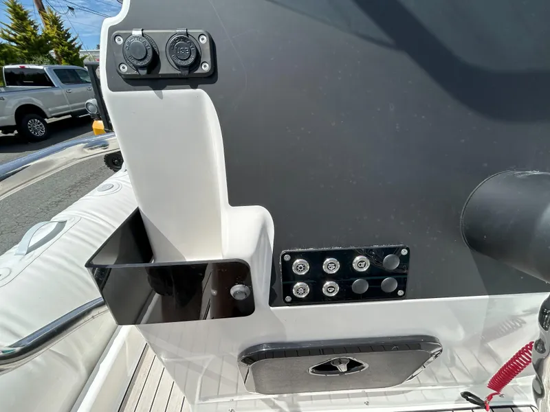 Slide: The Image of 2024 Zodiac Medline 6.8 boat console with USB ports and control panel. - 7